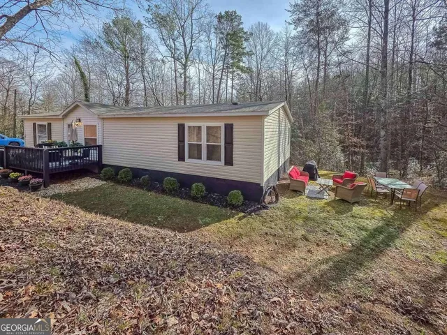 a view of a house with a yard and garage