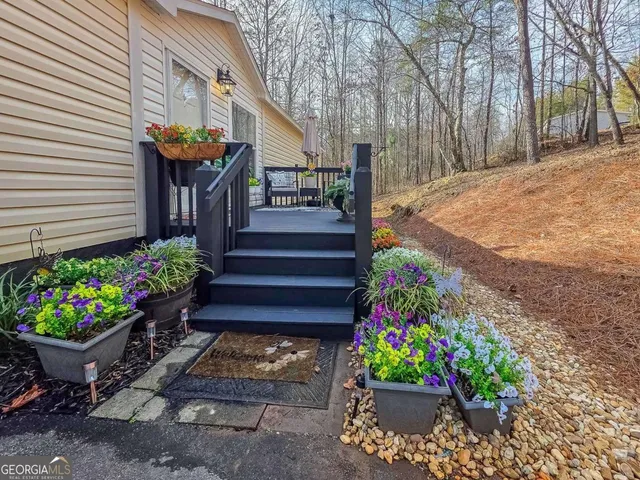 a front view of a house with a yard and a garden