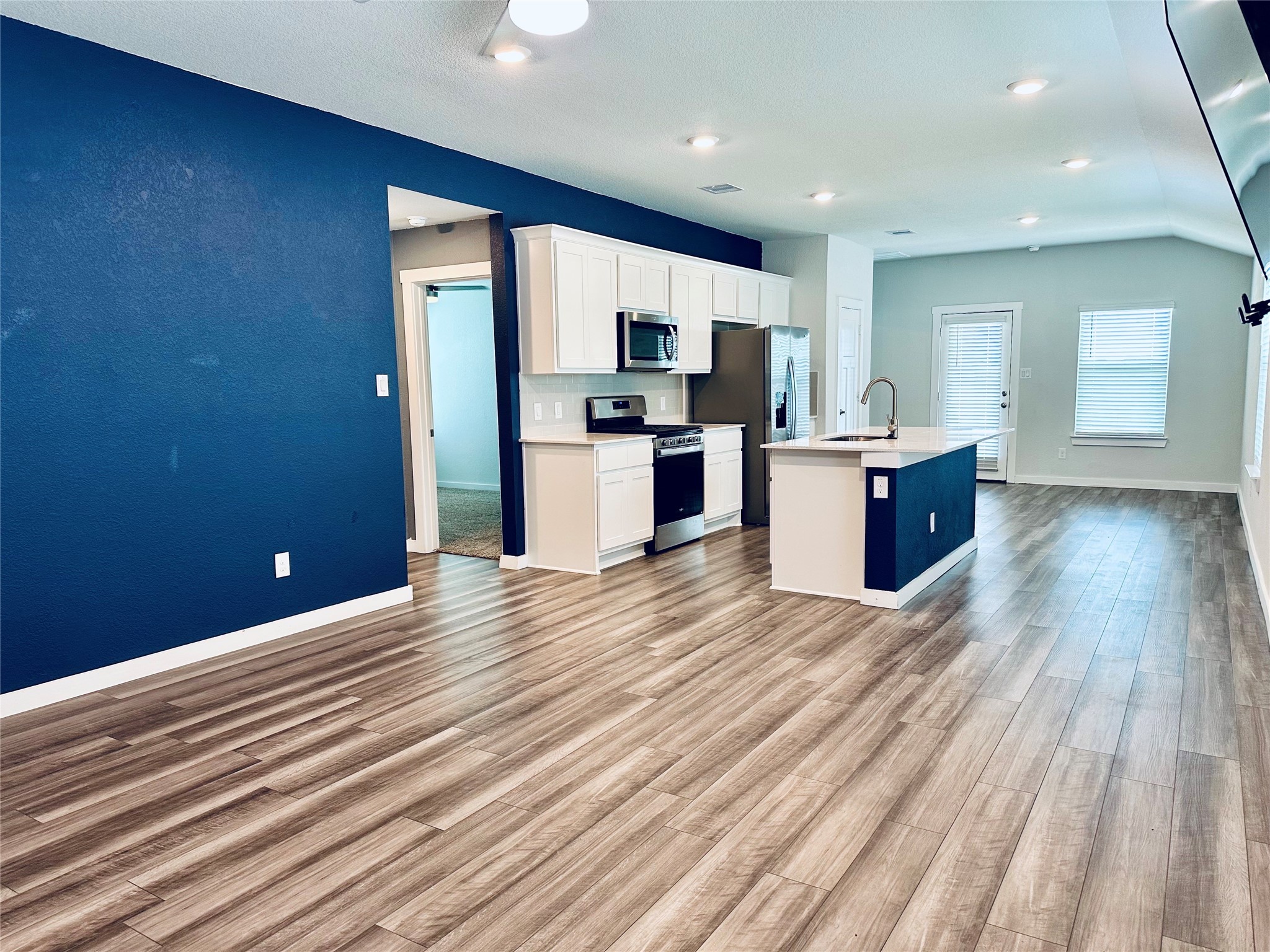 1118 Amistad Loop College Station, TX 77845 - Photo 3 of 26 a kitchen with stainless steel appliances kitchen island wooden cabinets and granite counter tops