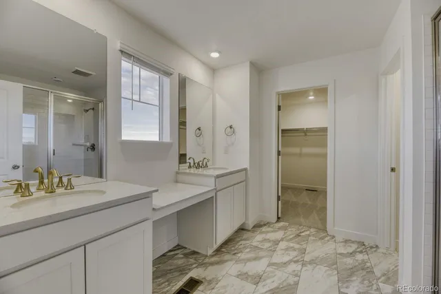 a spacious bathroom with a shower sink and mirror