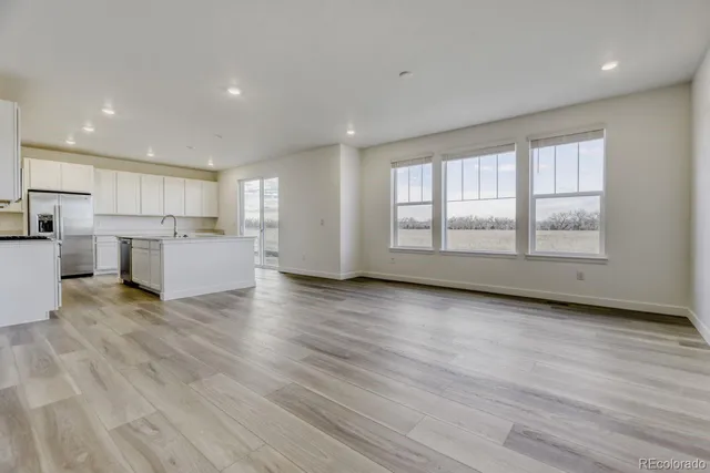 a view of a kitchen with a sink and wooden floor