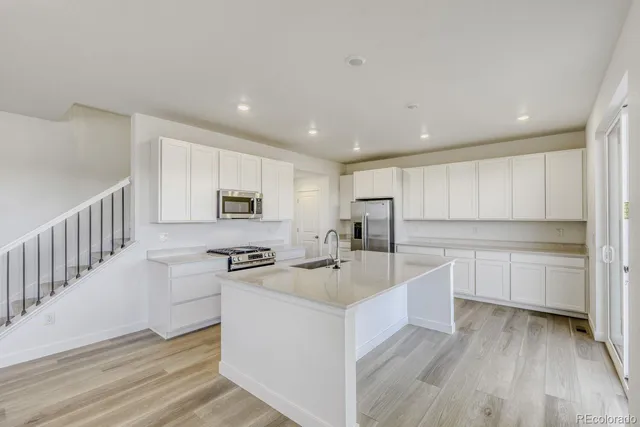 a kitchen with counter top space sink stove and oven