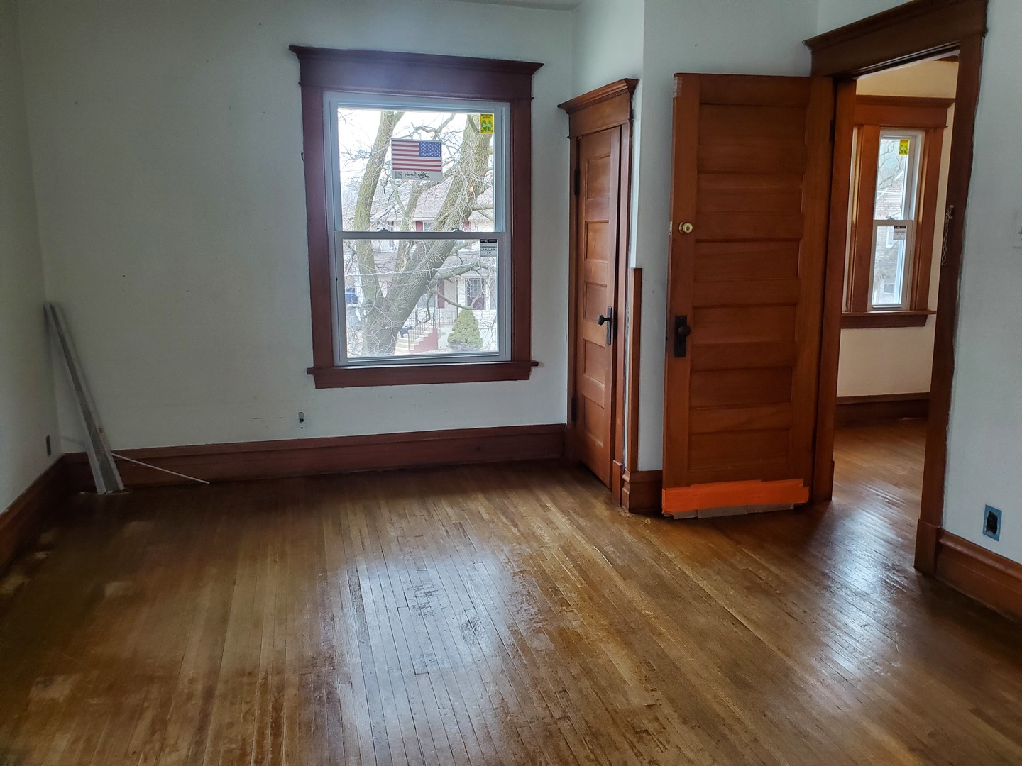 136 John Street DeKalb, IL 60115 - Photo 17 of 25 an empty room with wooden floor and windows