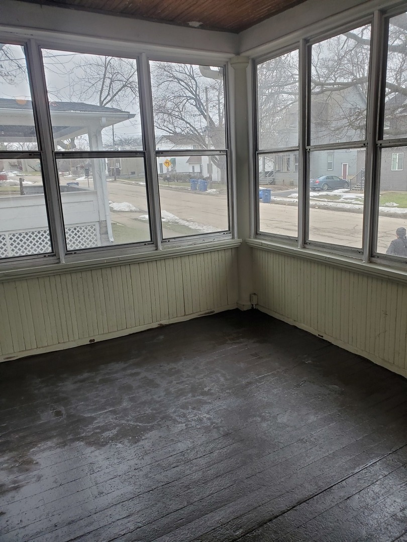 136 John Street DeKalb, IL 60115 - Photo 3 of 25 a view of an empty room with a window