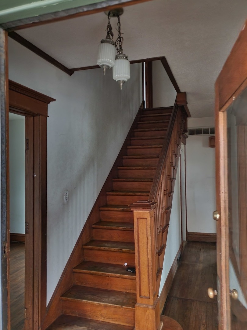 136 John Street DeKalb, IL 60115 - Photo 4 of 25 a view of entryway and hall with wooden floor