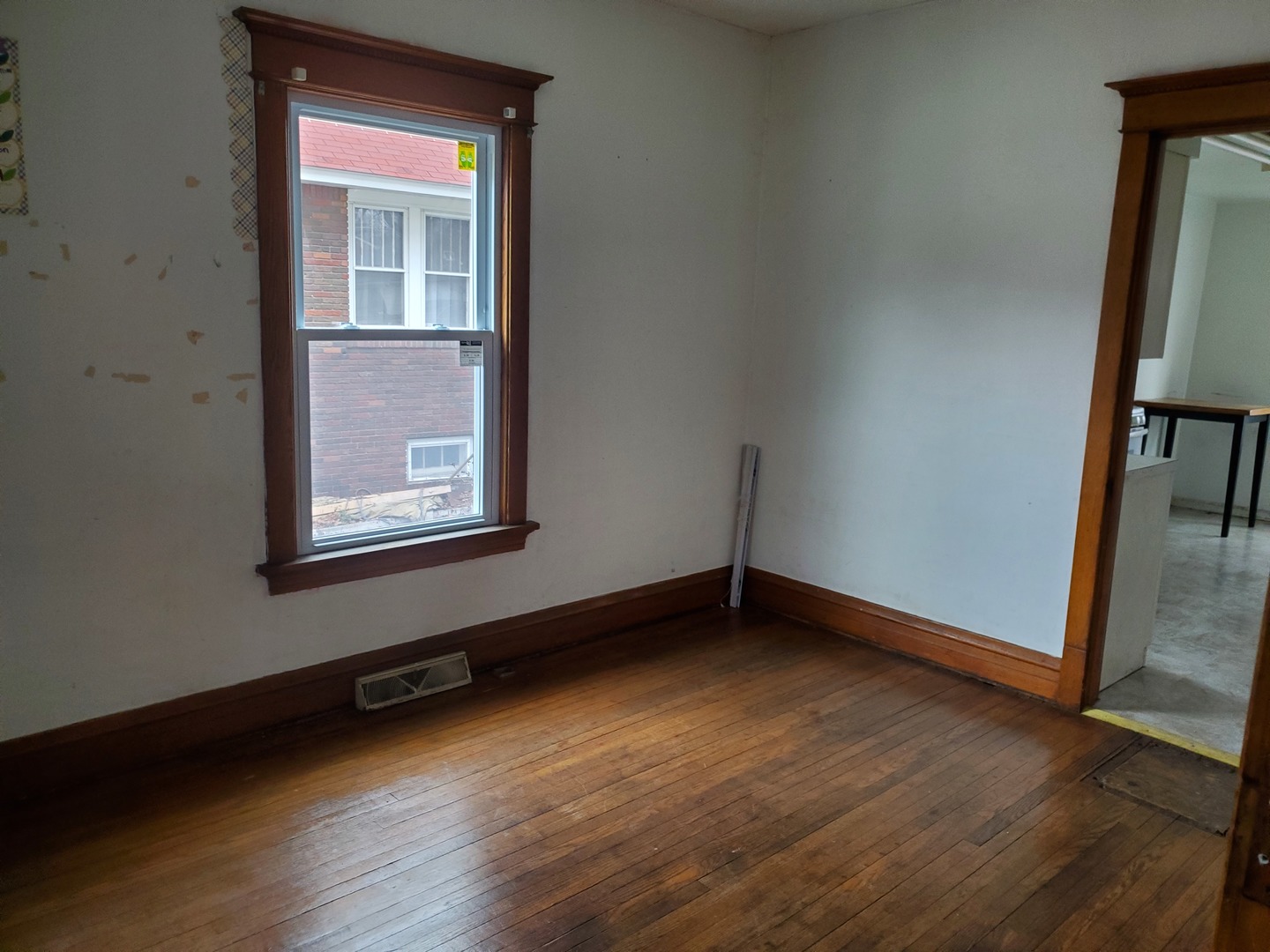 136 John Street DeKalb, IL 60115 - Photo 5 of 25 an empty room with wooden floor and windows