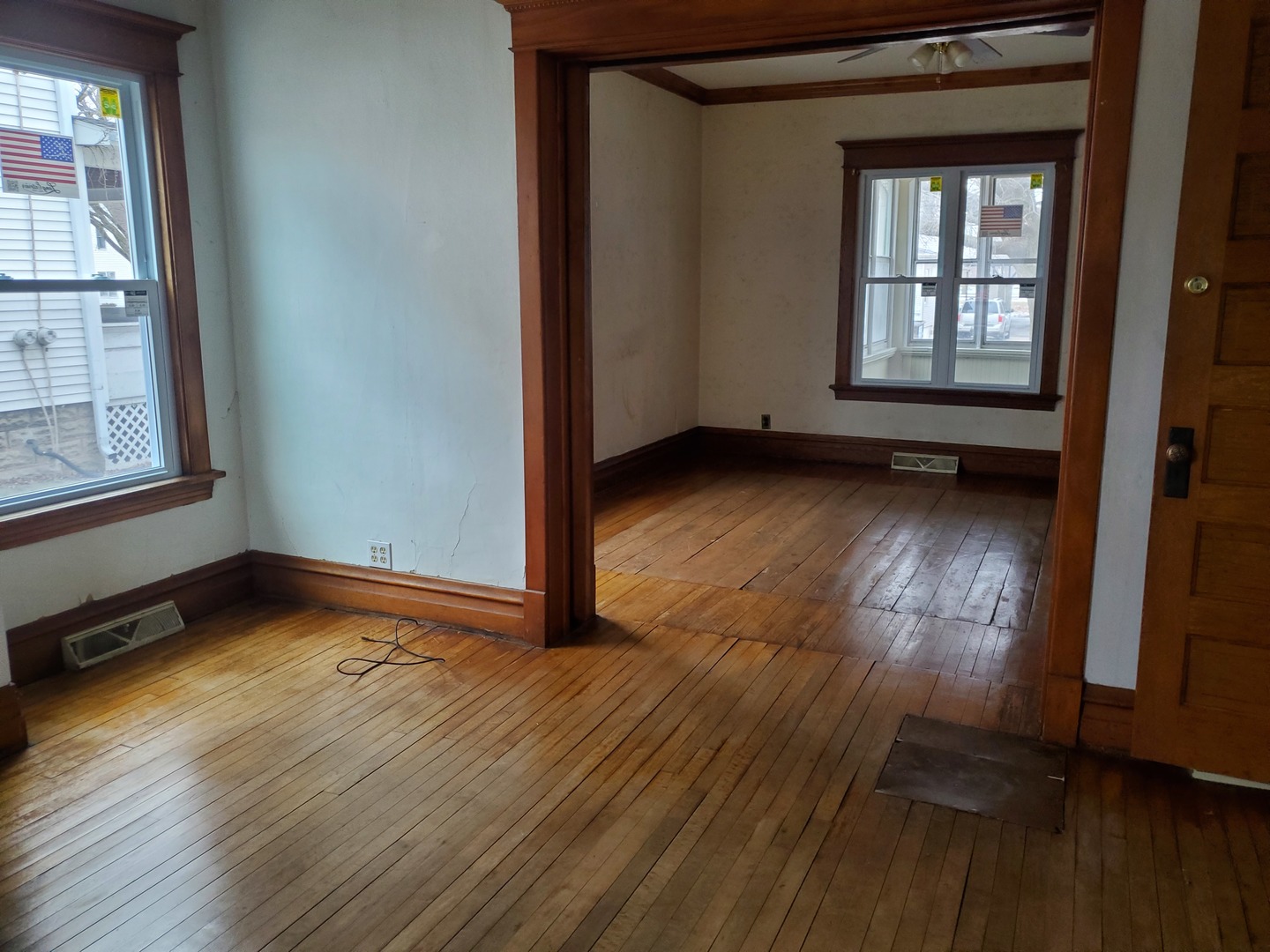 136 John Street DeKalb, IL 60115 - Photo 9 of 25 an empty room with wooden floor and windows