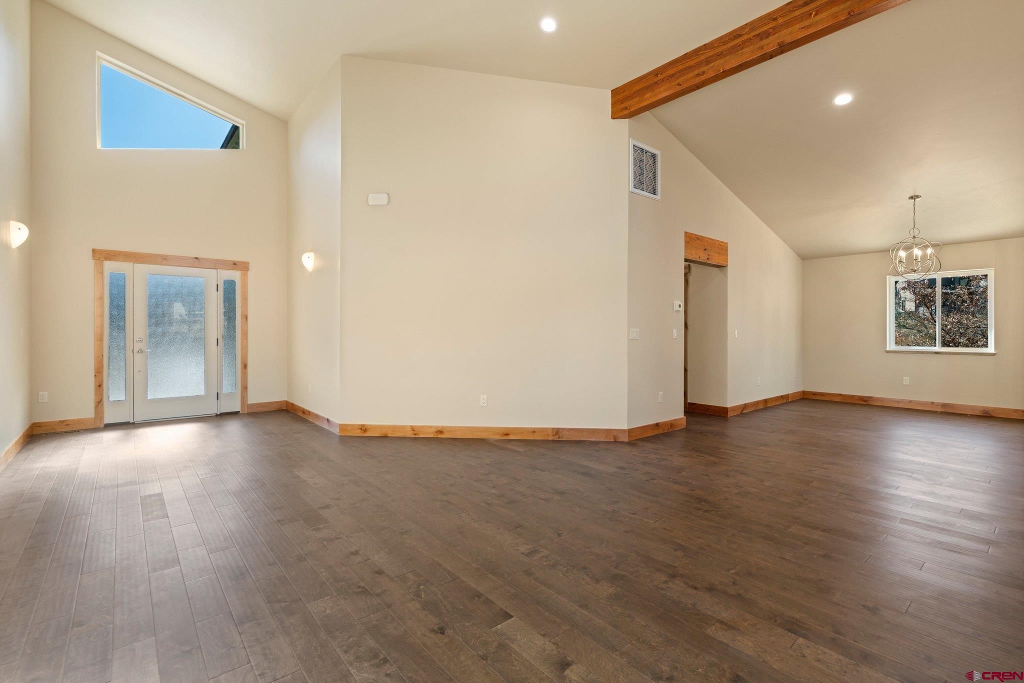 283 Edgemont Meadows Road Durango, CO 81301 - Photo 11 of 34 a view of an empty room with wooden floor and a window