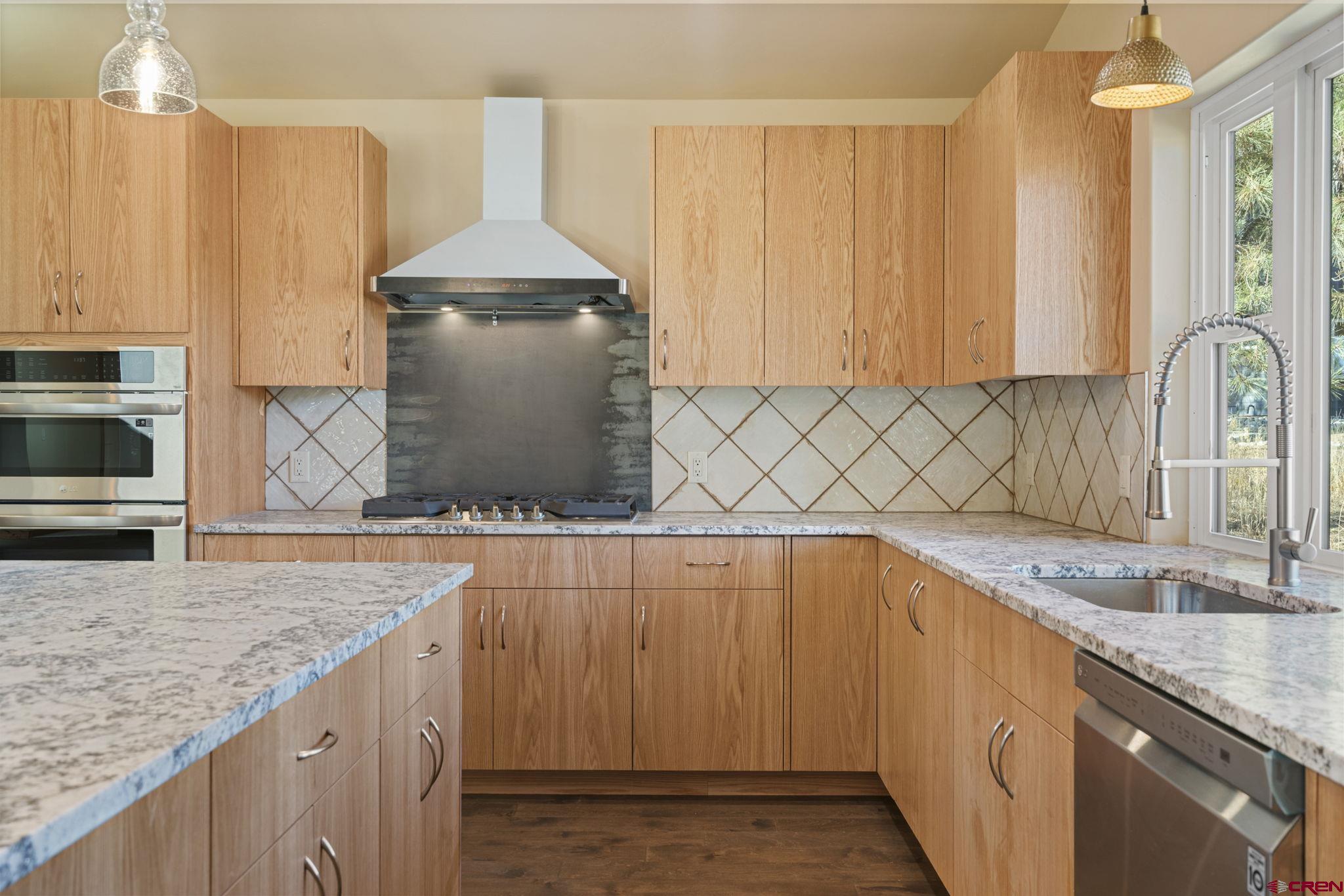 283 Edgemont Meadows Road Durango, CO 81301 - Photo 13 of 34 a kitchen with a sink stove and cabinets