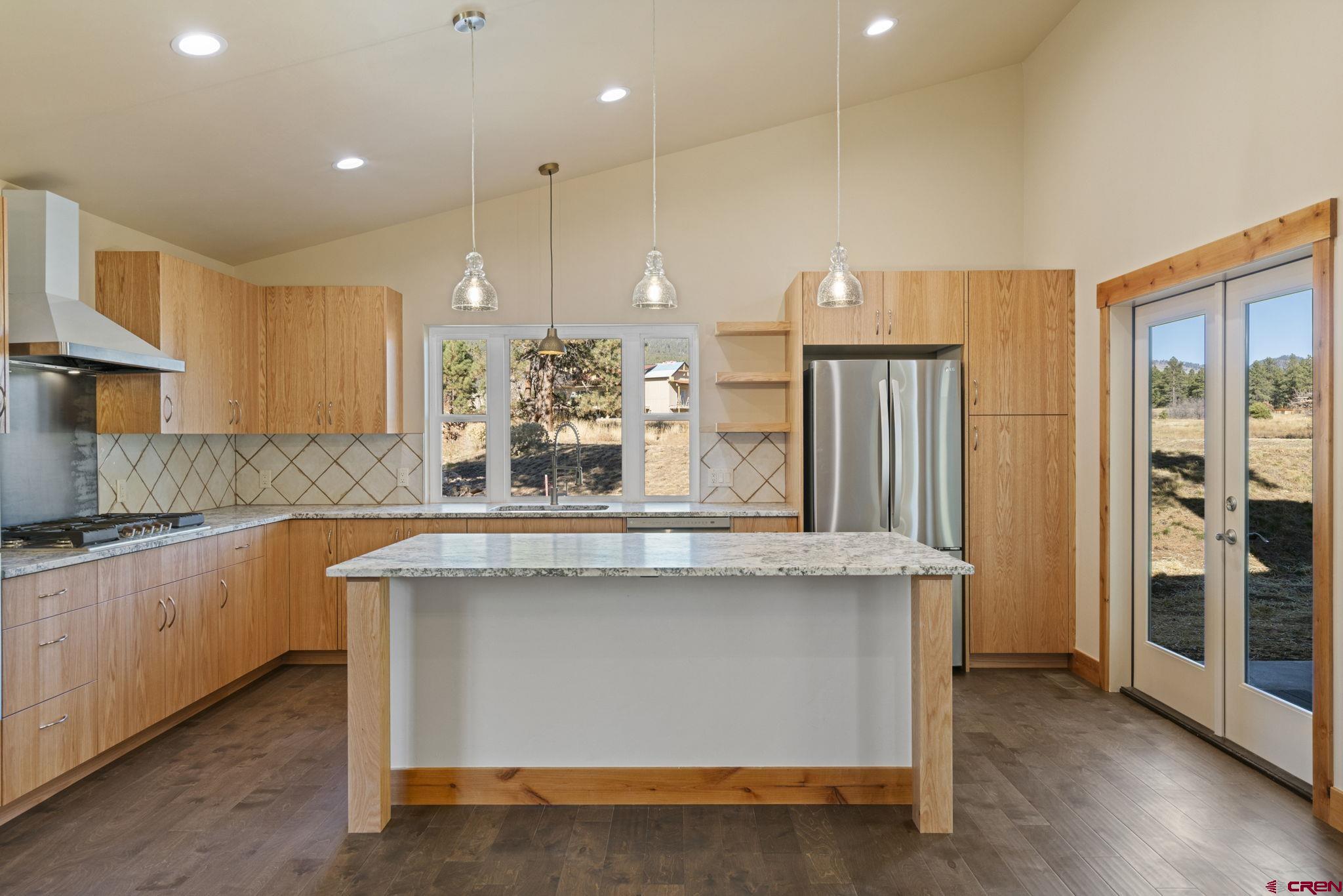 283 Edgemont Meadows Road Durango, CO 81301 - Photo 14 of 34 a kitchen with stainless steel appliances granite countertop a sink a stove and a refrigerator
