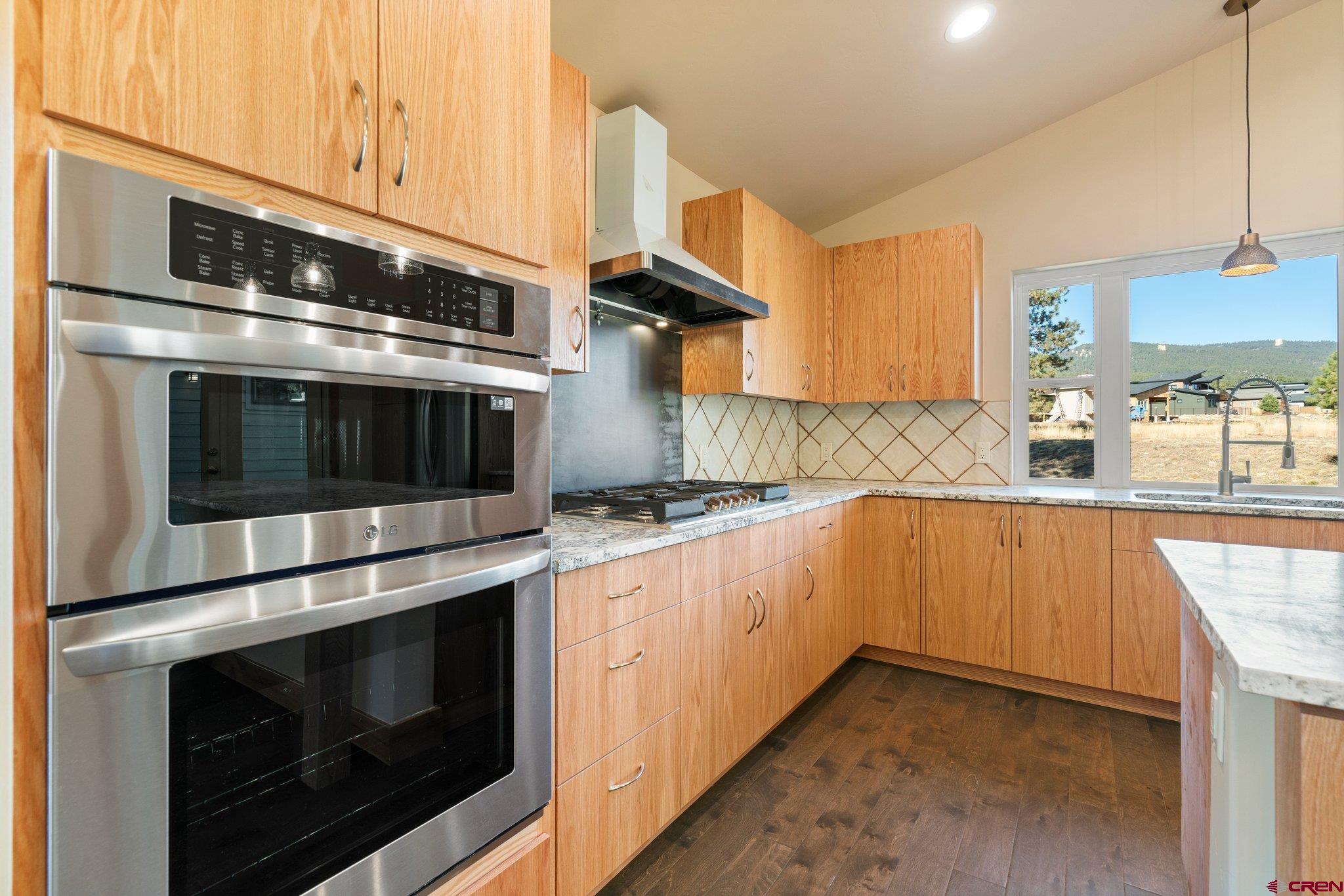 283 Edgemont Meadows Road Durango, CO 81301 - Photo 15 of 34 a kitchen with stainless steel appliances granite countertop a stove microwave and sink