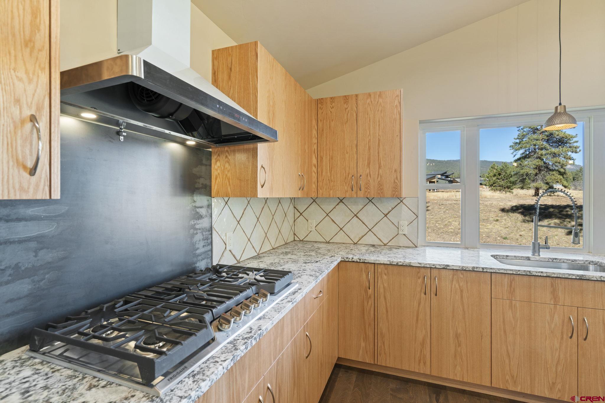 283 Edgemont Meadows Road Durango, CO 81301 - Photo 16 of 34 a kitchen with granite countertop a stove and a sink
