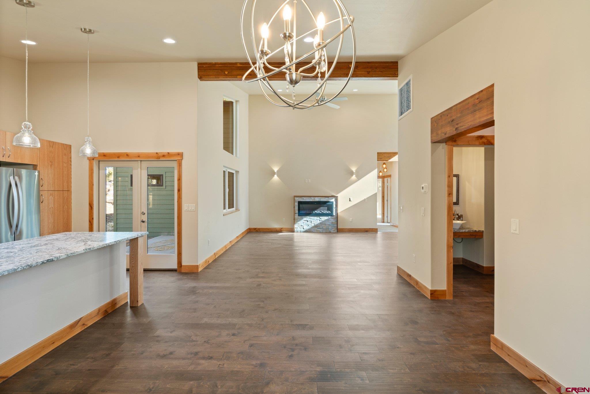 283 Edgemont Meadows Road Durango, CO 81301 - Photo 19 of 34 a view of a big room with chandelier and wooden floor
