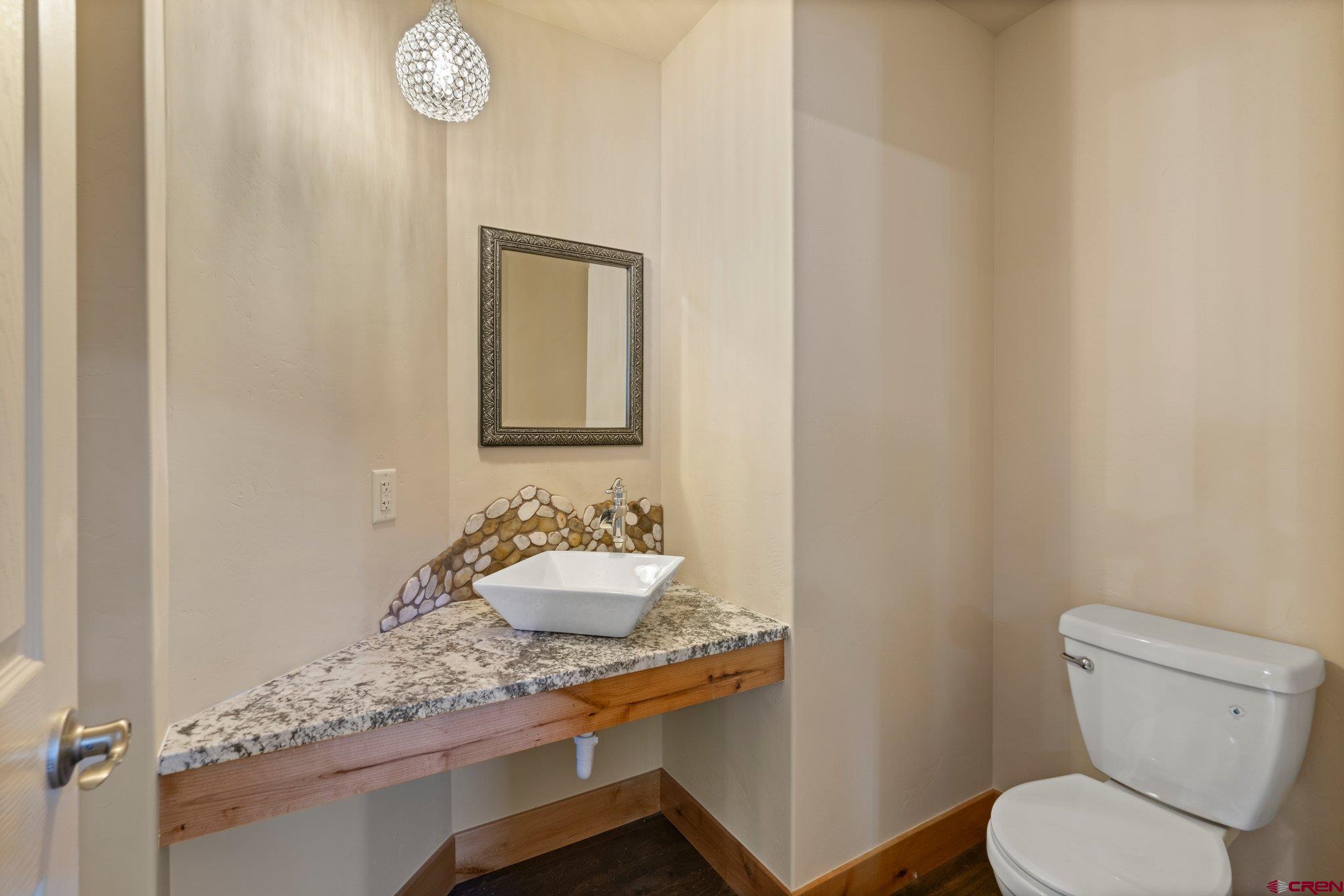 283 Edgemont Meadows Road Durango, CO 81301 - Photo 21 of 34 a bathroom with a toilet sink and mirror