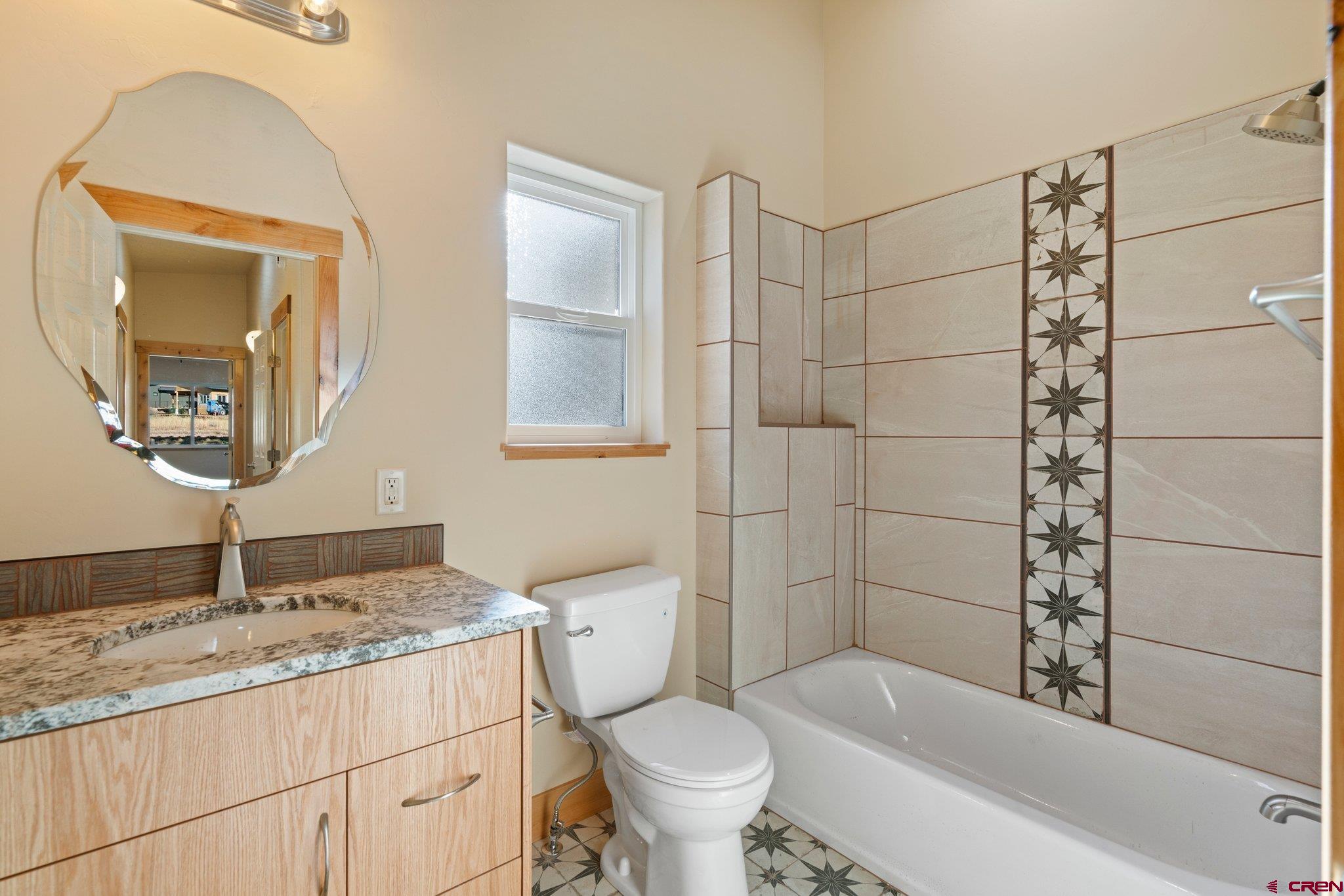 283 Edgemont Meadows Road Durango, CO 81301 - Photo 24 of 34 a bathroom with a granite countertop toilet sink and mirror