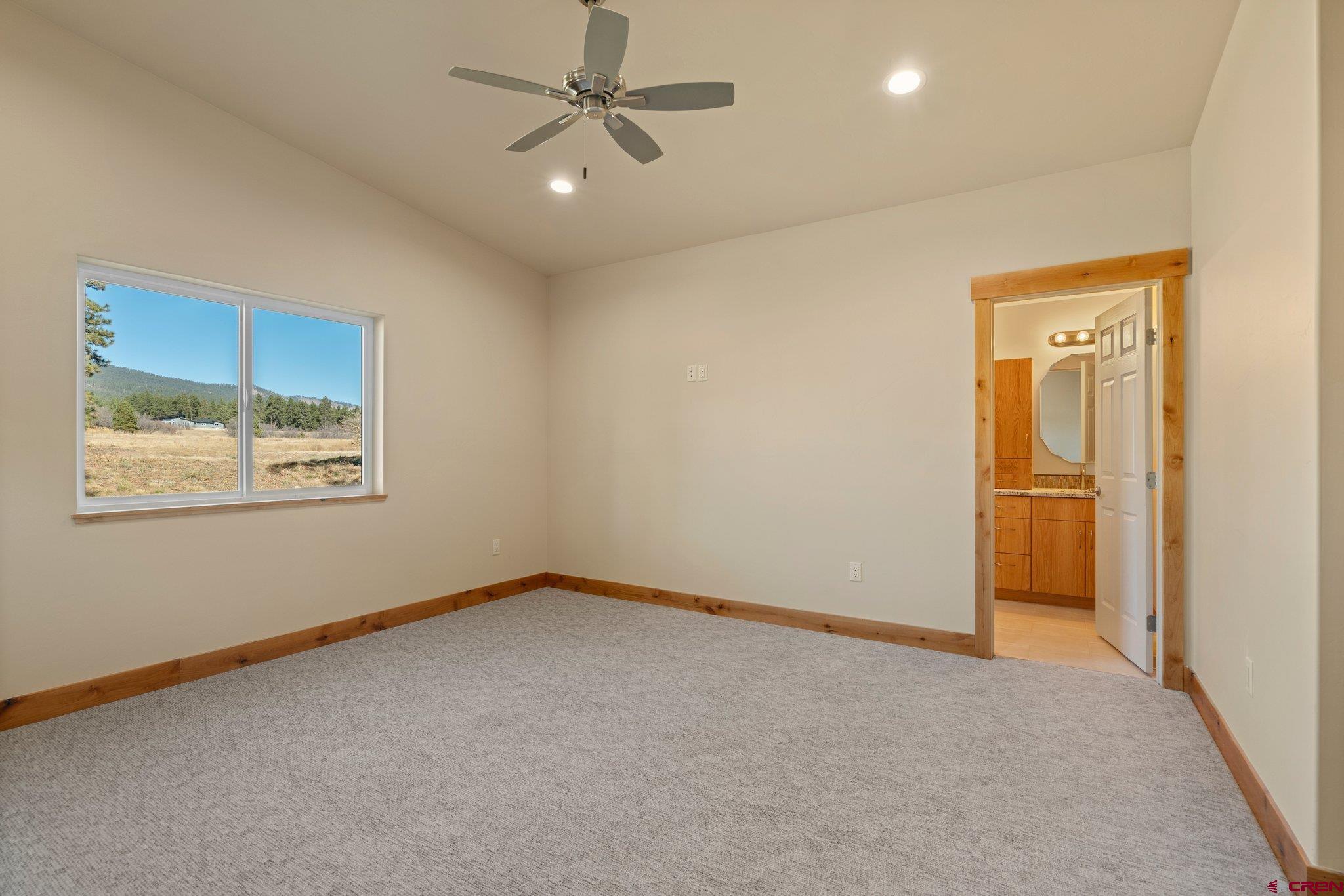 283 Edgemont Meadows Road Durango, CO 81301 - Photo 29 of 34 an empty room with a window and ceiling fan