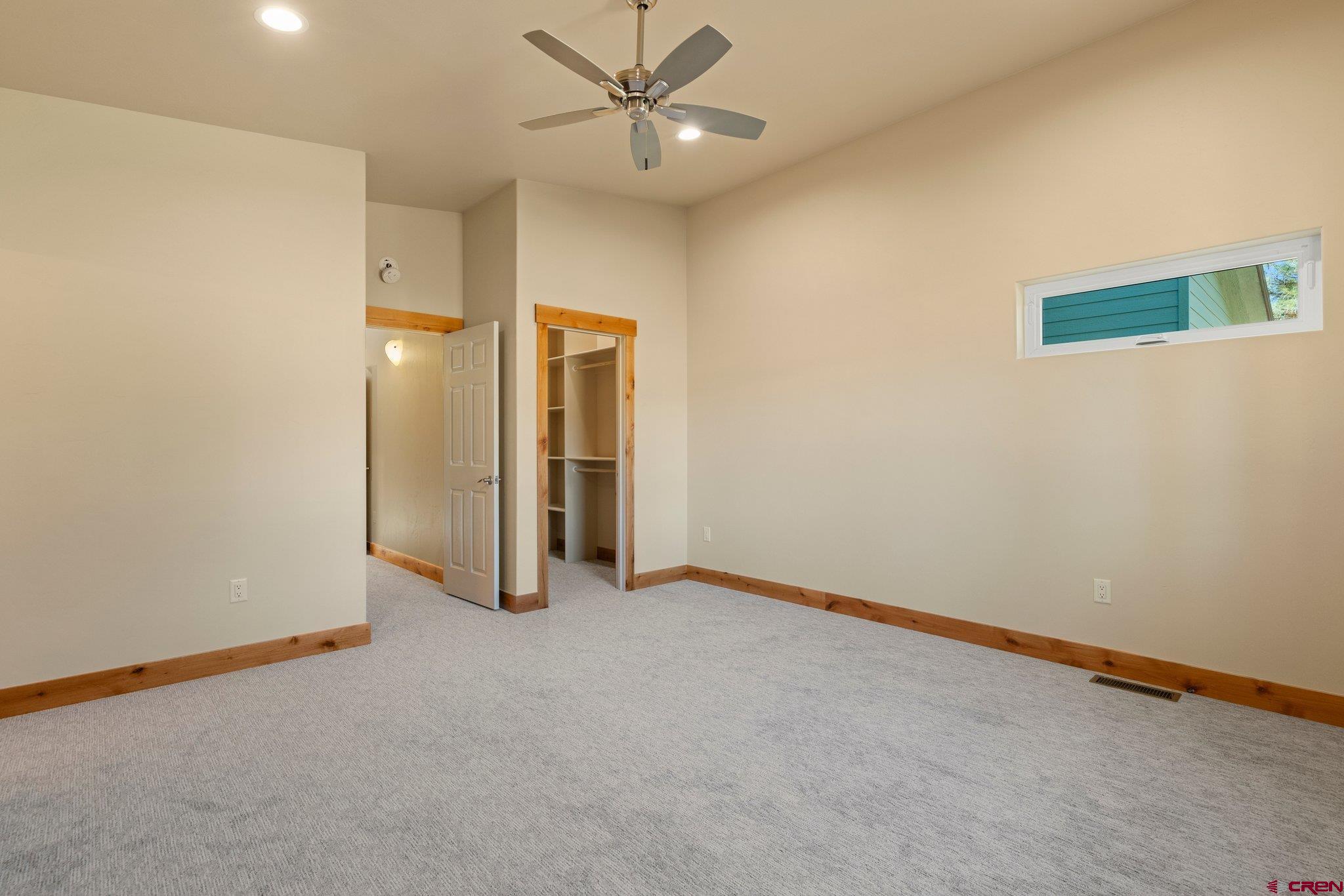283 Edgemont Meadows Road Durango, CO 81301 - Photo 31 of 34 an empty room with closet and a ceiling fan