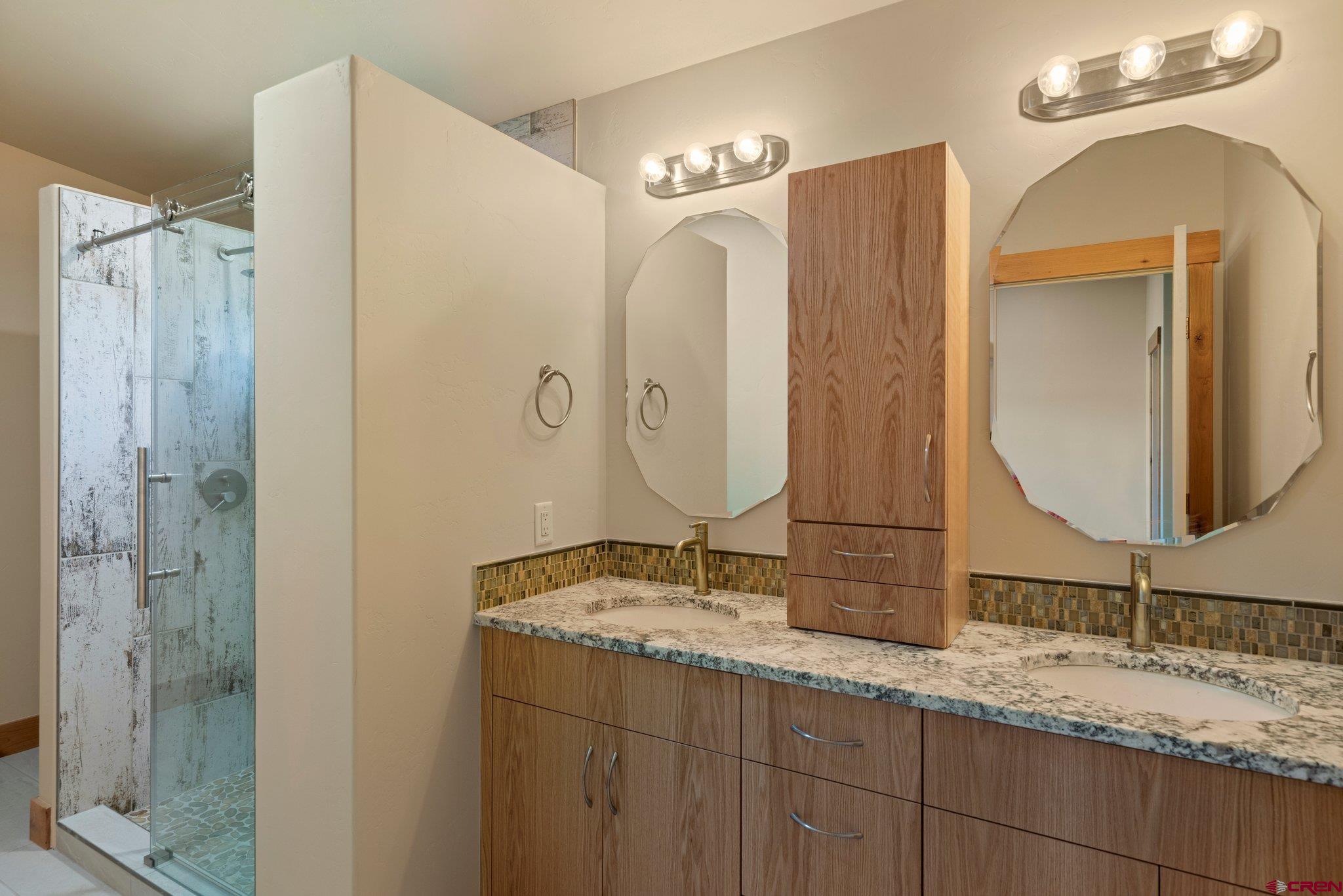 283 Edgemont Meadows Road Durango, CO 81301 - Photo 32 of 34 a bathroom with a granite countertop double vanity sink and mirror