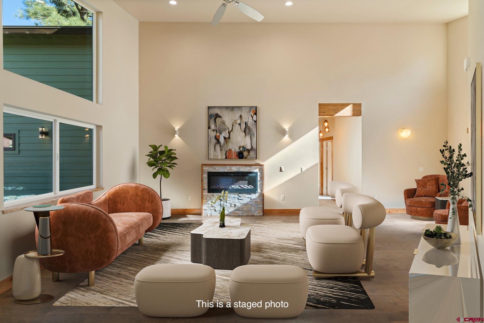 283 Edgemont Meadows Road Durango, CO 81301 - Photo 9 of 34 a living room with fireplace furniture and a large window