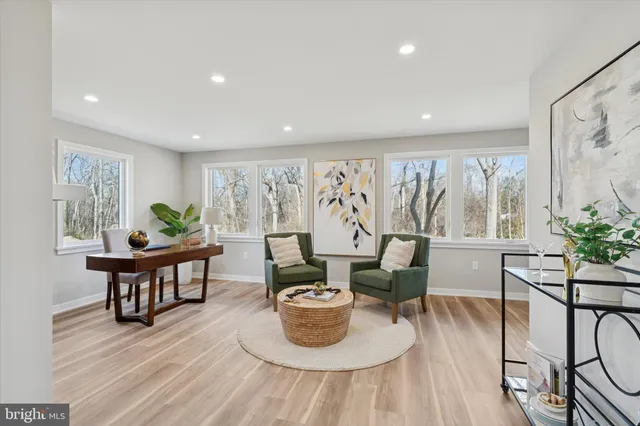 a living room with furniture and a painting on the wall