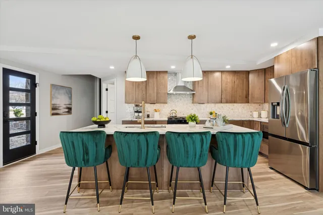 a kitchen with a table chairs sink and cabinets