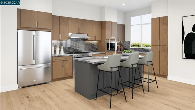 a kitchen with stainless steel appliances a refrigerator a stove a sink cabinets and a dining table