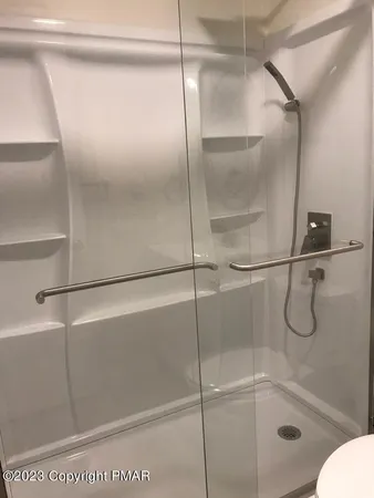 a bathroom with a glass shower door