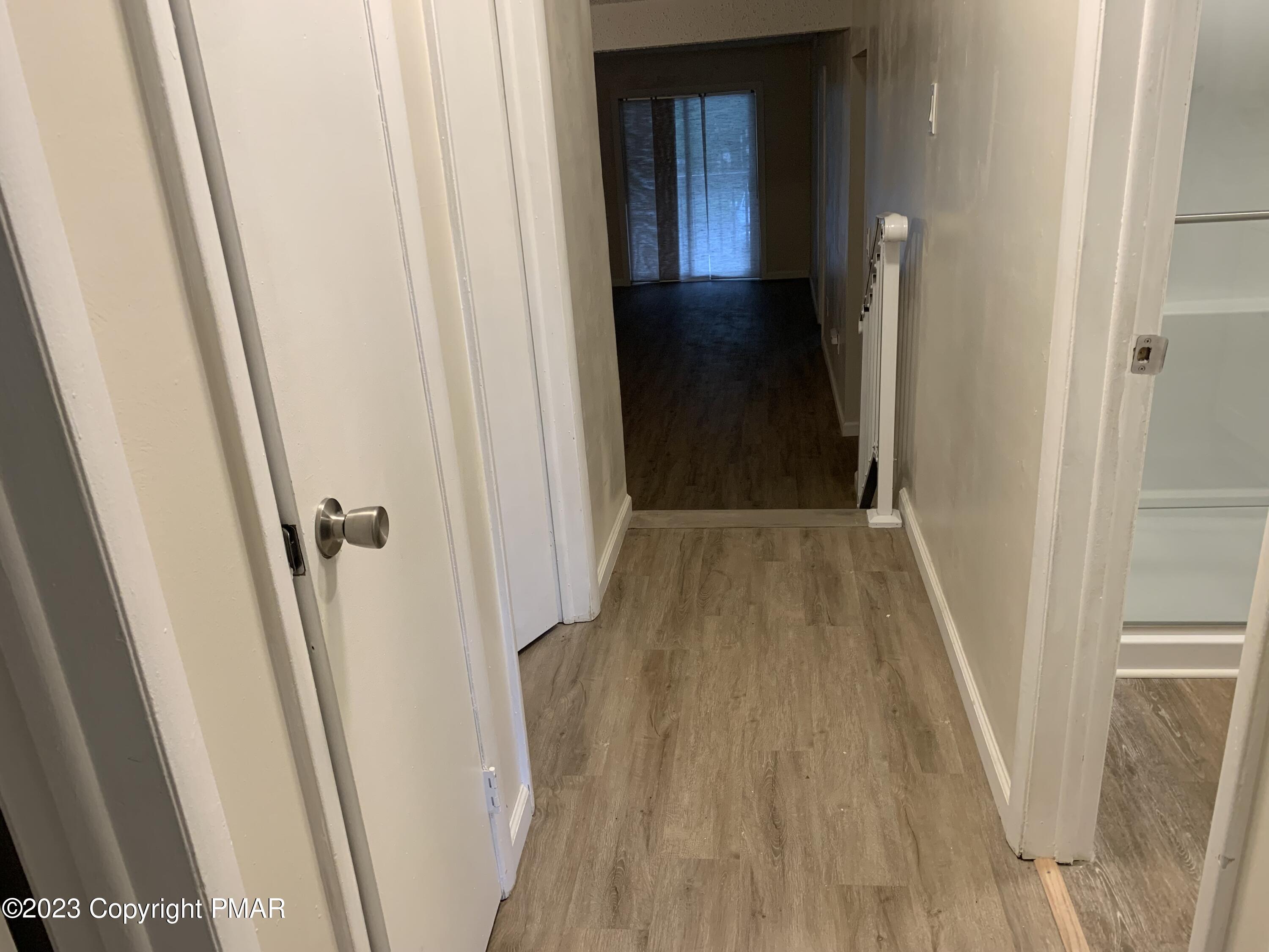 130 View Court, Unit 103 Mount Pocono, PA 18344 - Photo 5 of 11 a view of a hallway with wooden floor and staircase