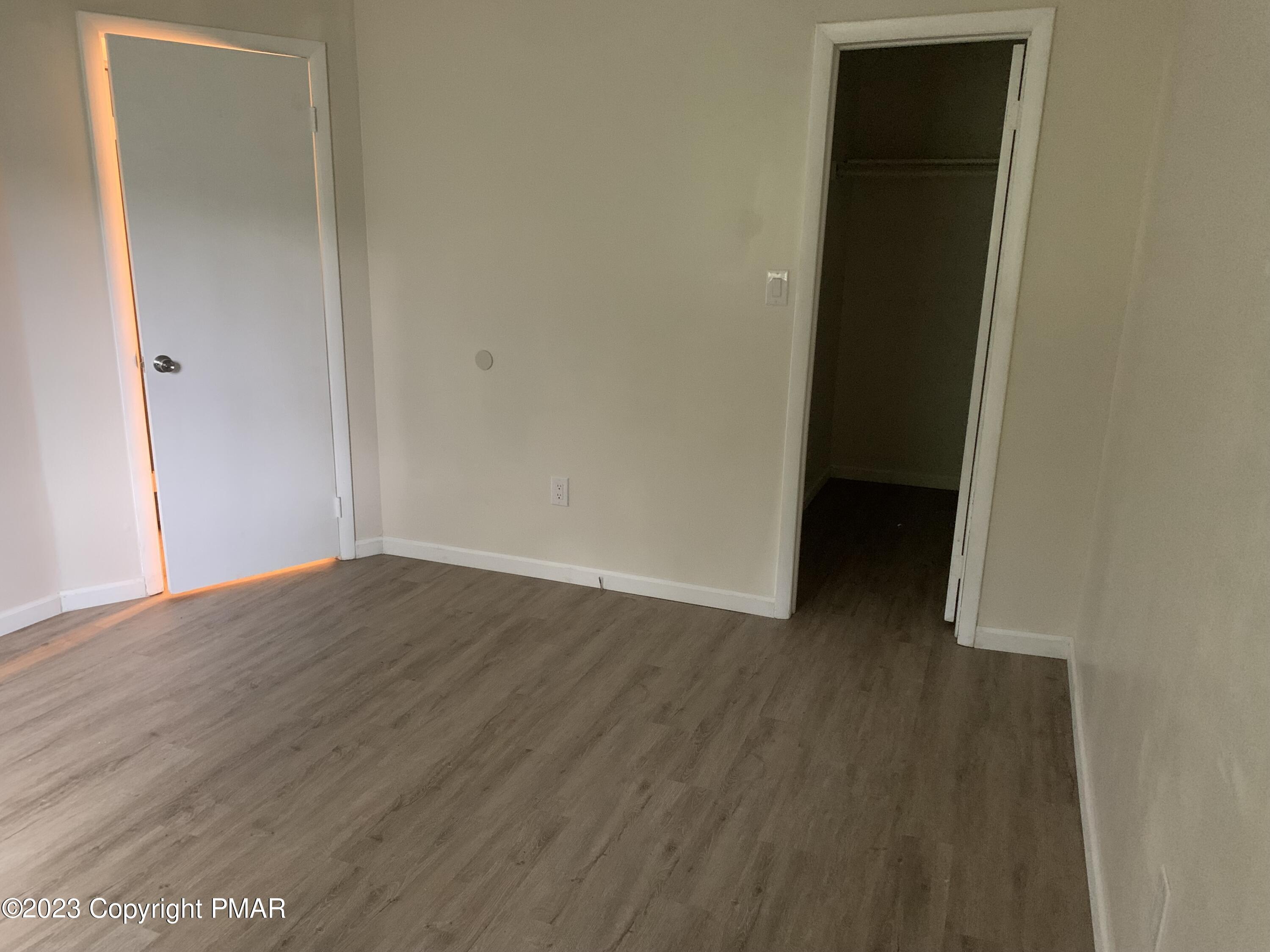 130 View Court, Unit 103 Mount Pocono, PA 18344 - Photo 7 of 11 an empty room with wooden floor and closet