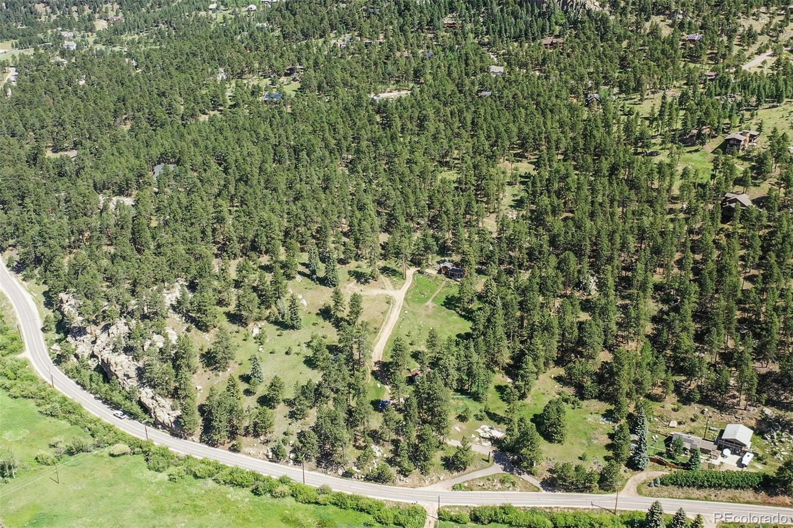 Two entry point's from Hwy 73 where they merge to one drive way up to the top. Overall aerial of land shows driveway midway up is 2nd residence, drive continues up into the trees.  Property backs up to Evergreen Highlands in rear