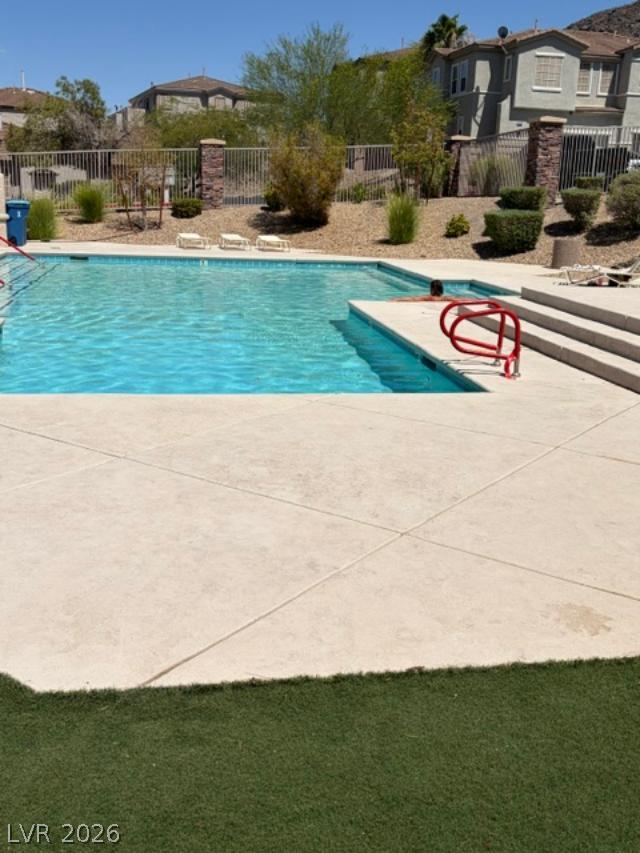 231 Positive Point Street Henderson, NV 89012 - Photo 2 of 2 A refreshing pool awaits, perfect for a sunny afternoon in a vibrant community.