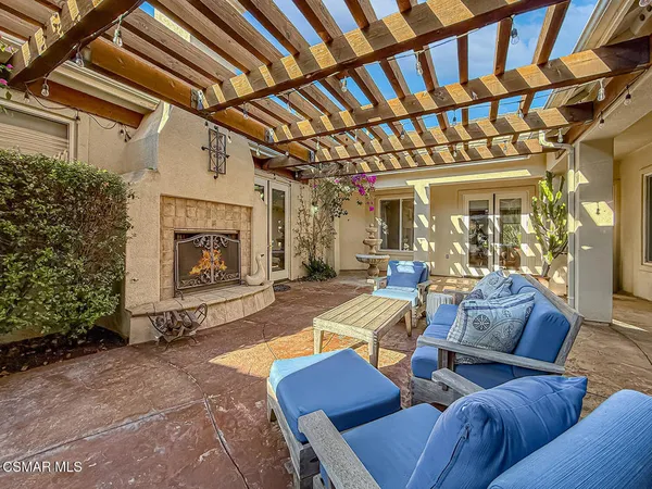 a view of a swimming pool with lawn chairs and a big yard