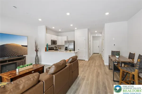 a living room with furniture and kitchen view