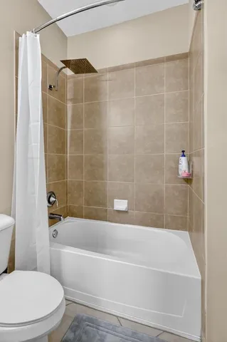 a bathroom with a bathtub and a toilet