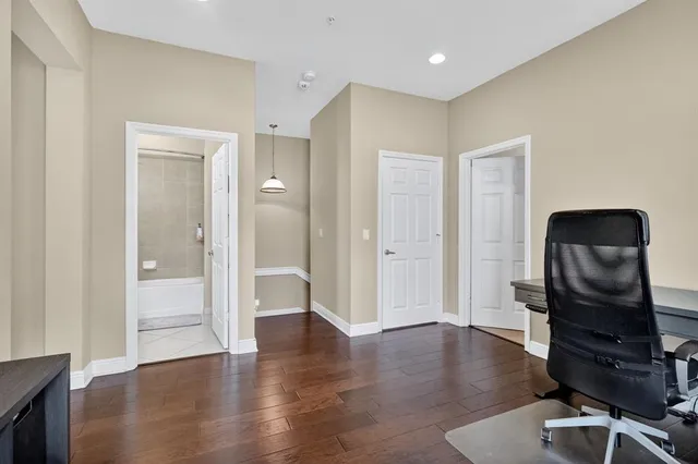 a view of a workspace with wooden floor and bathroom