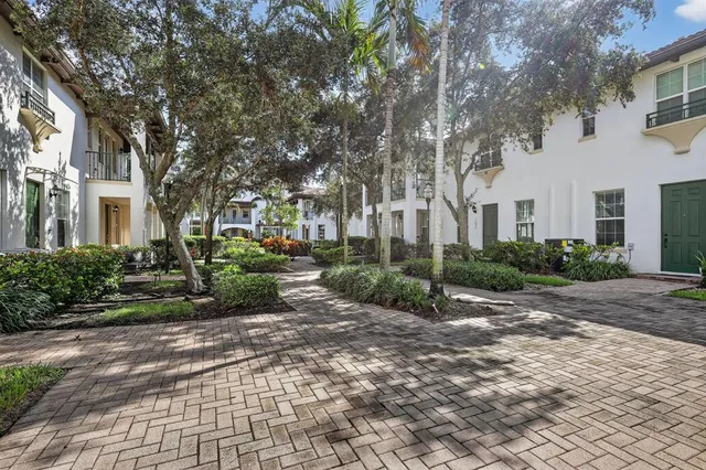 a view of a building with a bench in backyard