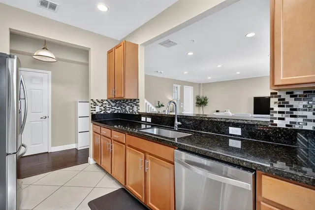 a kitchen with stainless steel appliances granite countertop a sink and a counter space