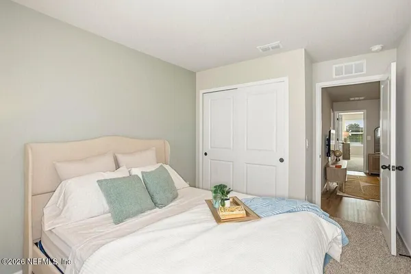 a bedroom with a bed and a walk in closet