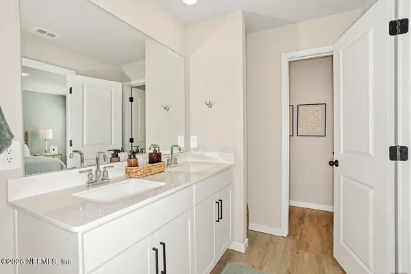 a bathroom with a sink a mirror and a shower