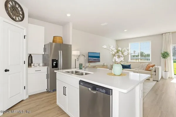 a kitchen with a sink cabinets and refrigerator