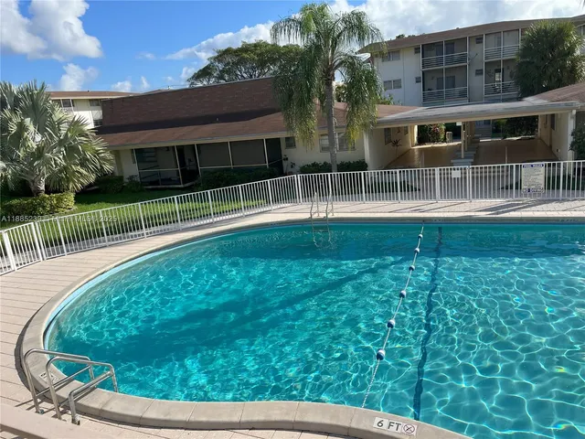 a view of house with a backyard