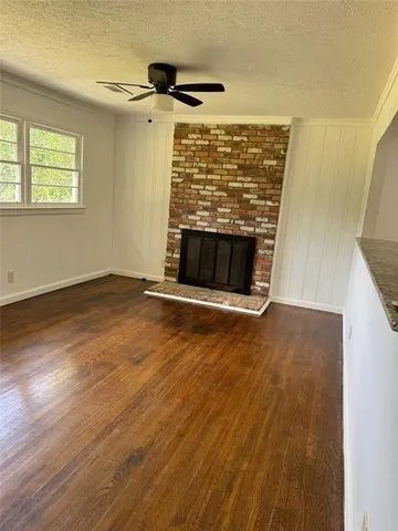 an empty room with wooden floor and white walls