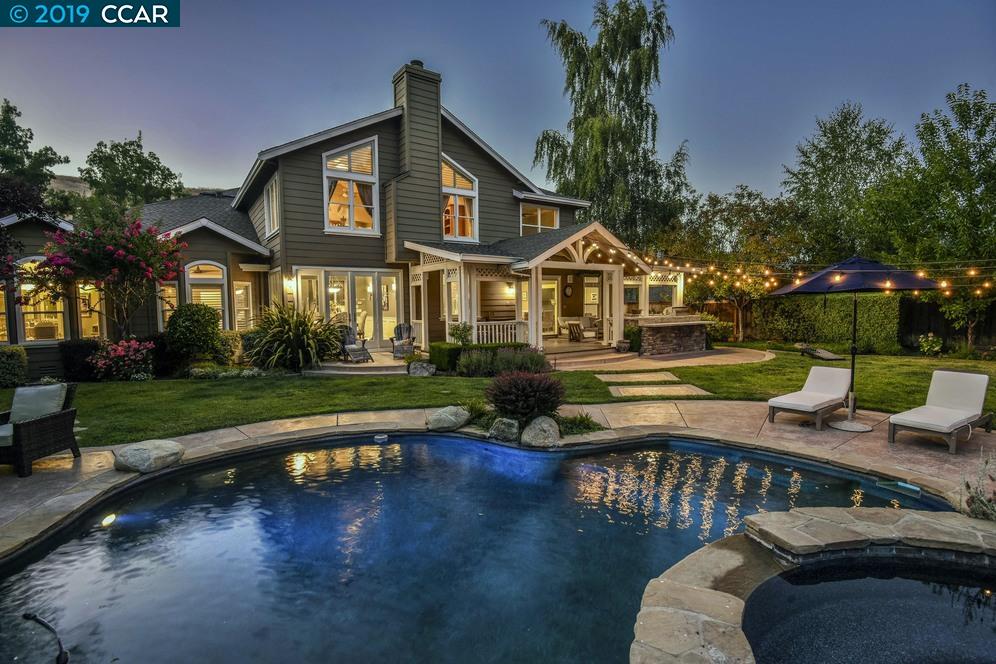 a front view of a house with swimming pool having outdoor seating