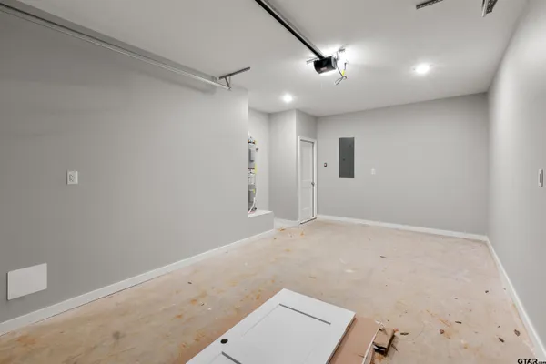 an empty room with a ceiling fan and window