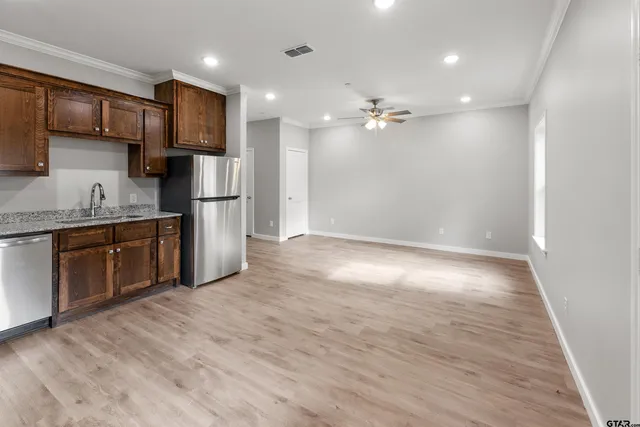 a view of kitchen with refrigerator furniture and a wooden floor