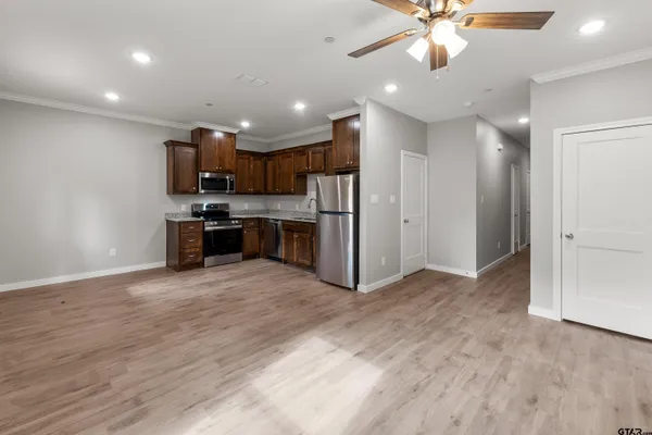 a view of kitchen with refrigerator and microwave