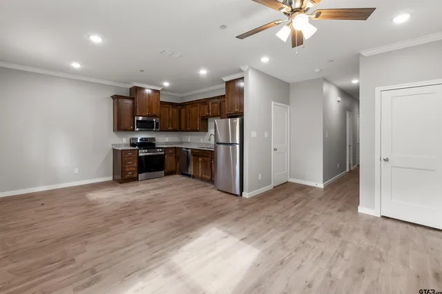 a view of kitchen with refrigerator and microwave