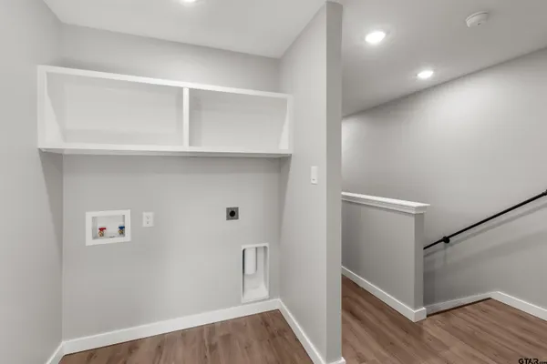 a view of hallway with wooden floor