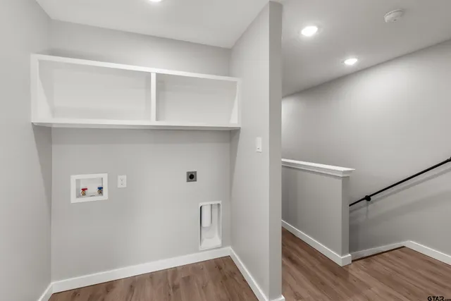 a view of hallway with wooden floor