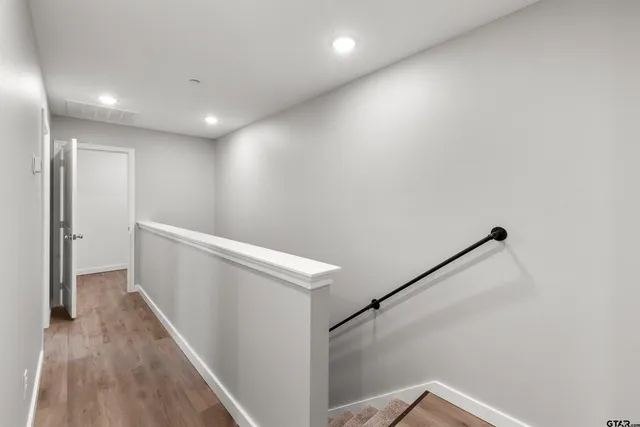 a view of a hallway with stairs